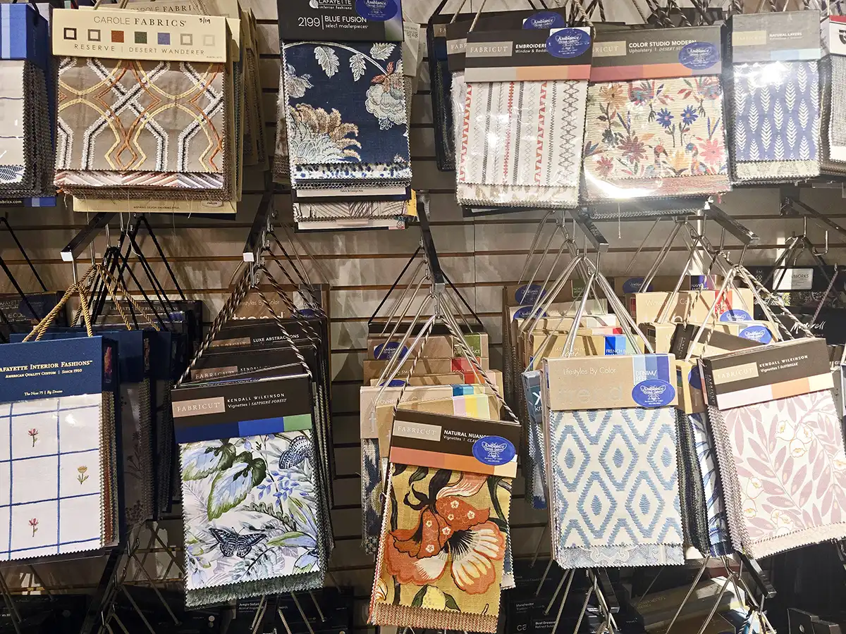 Interior designer helping select custom window treatments at Ambiance Design Gallery showroom